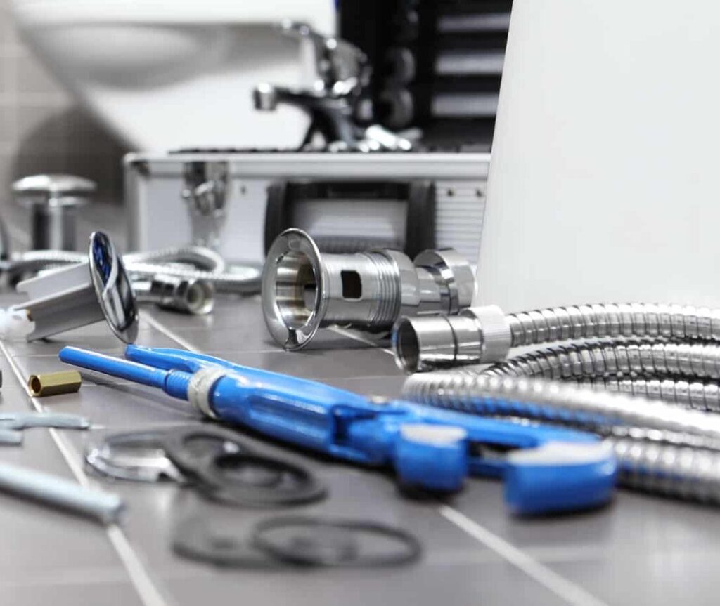 plumber at work in a bathroom, plumbing repair service, assemble and install concept